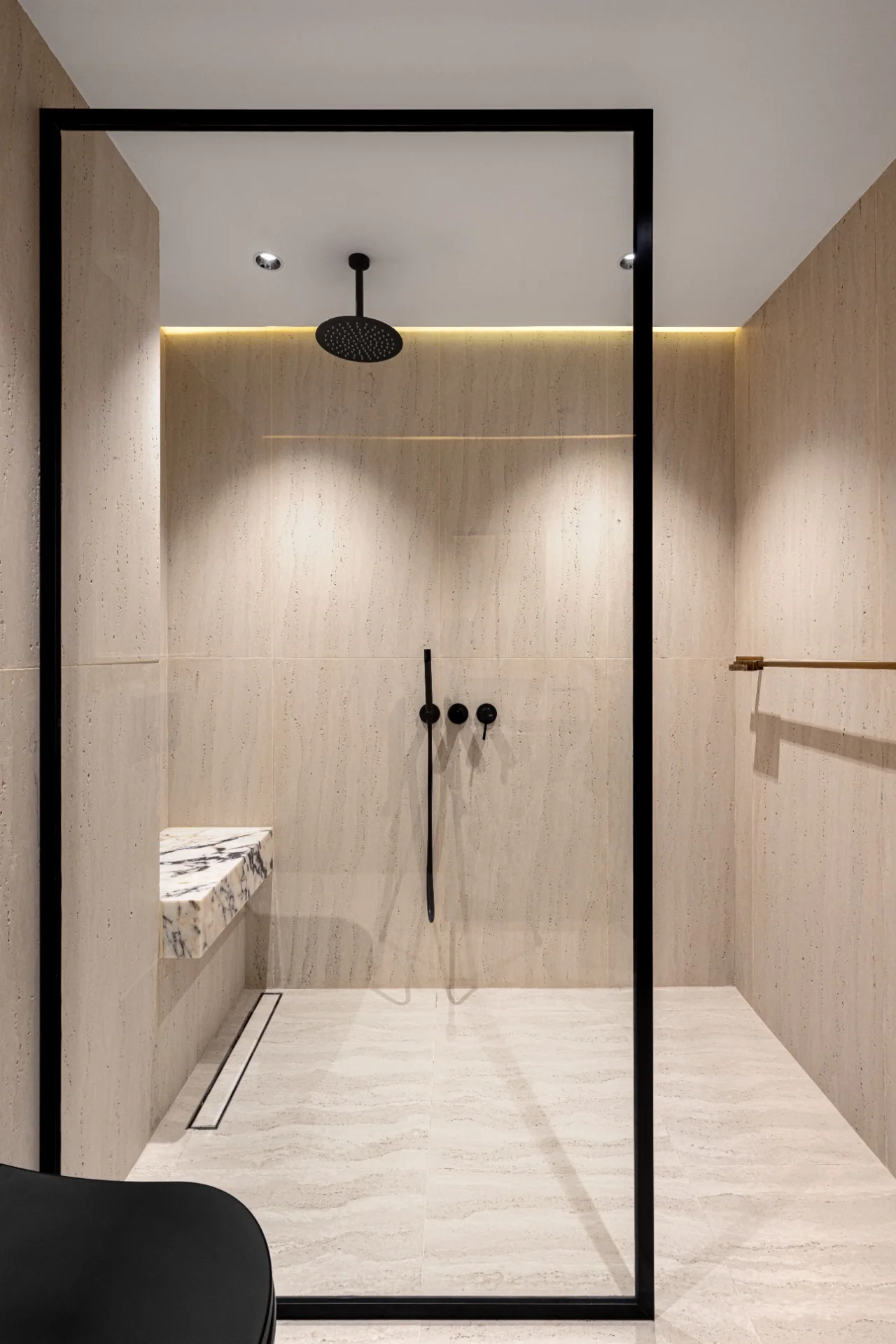 Bathroom with a glass shower enclosure and warm neutral walls